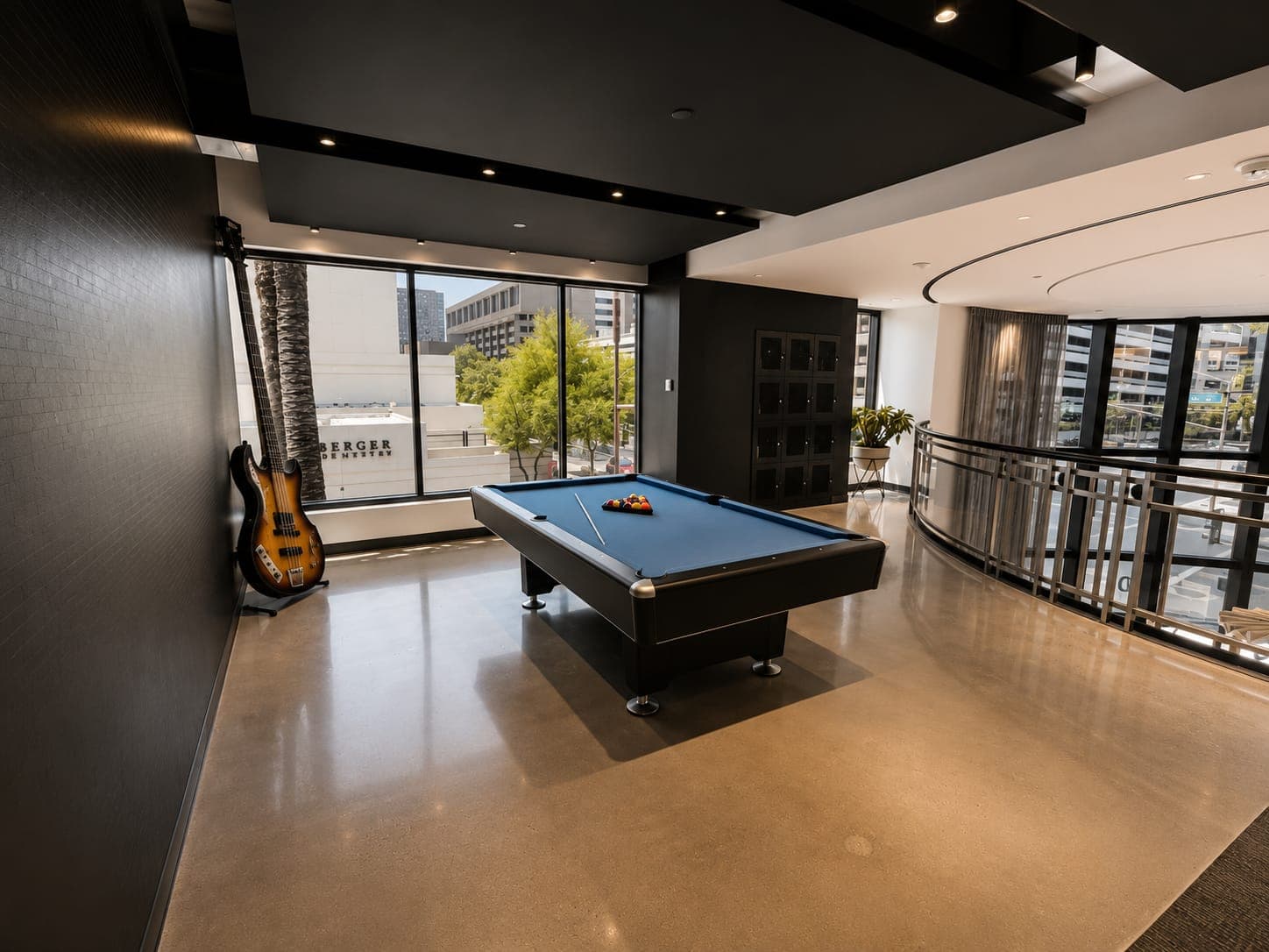 The pool table on the mezzanine lounge at 200 EVB, black rails and glass above the lobby