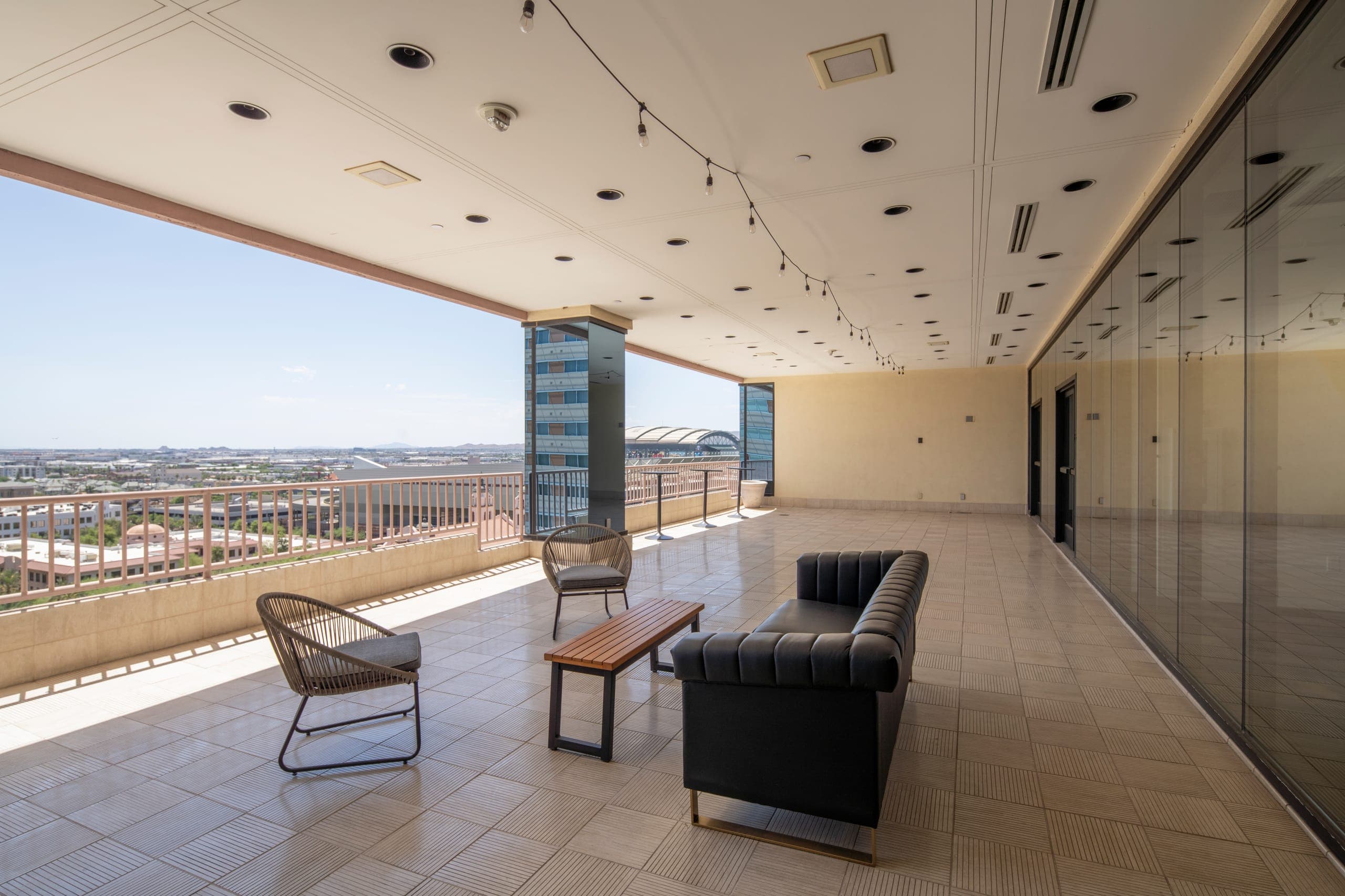 The covered terrace with lounge seating and views across Downtown Phoenix