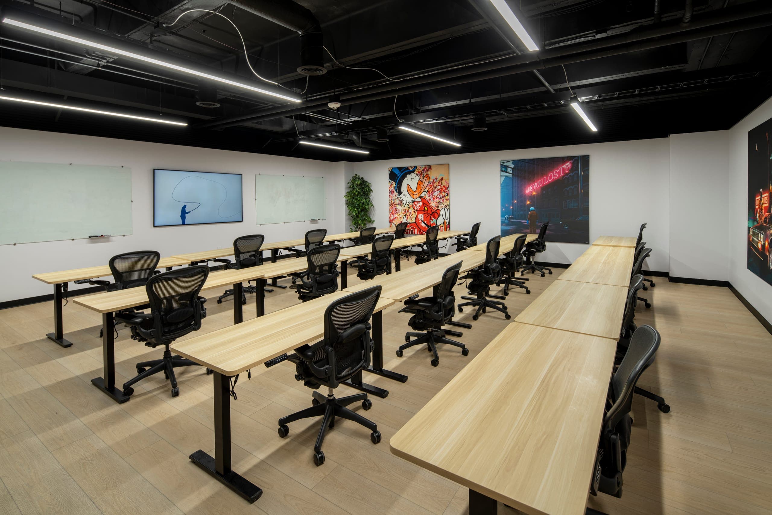 The Sonoran conference room, long tables, whiteboard, and art under a glass wall